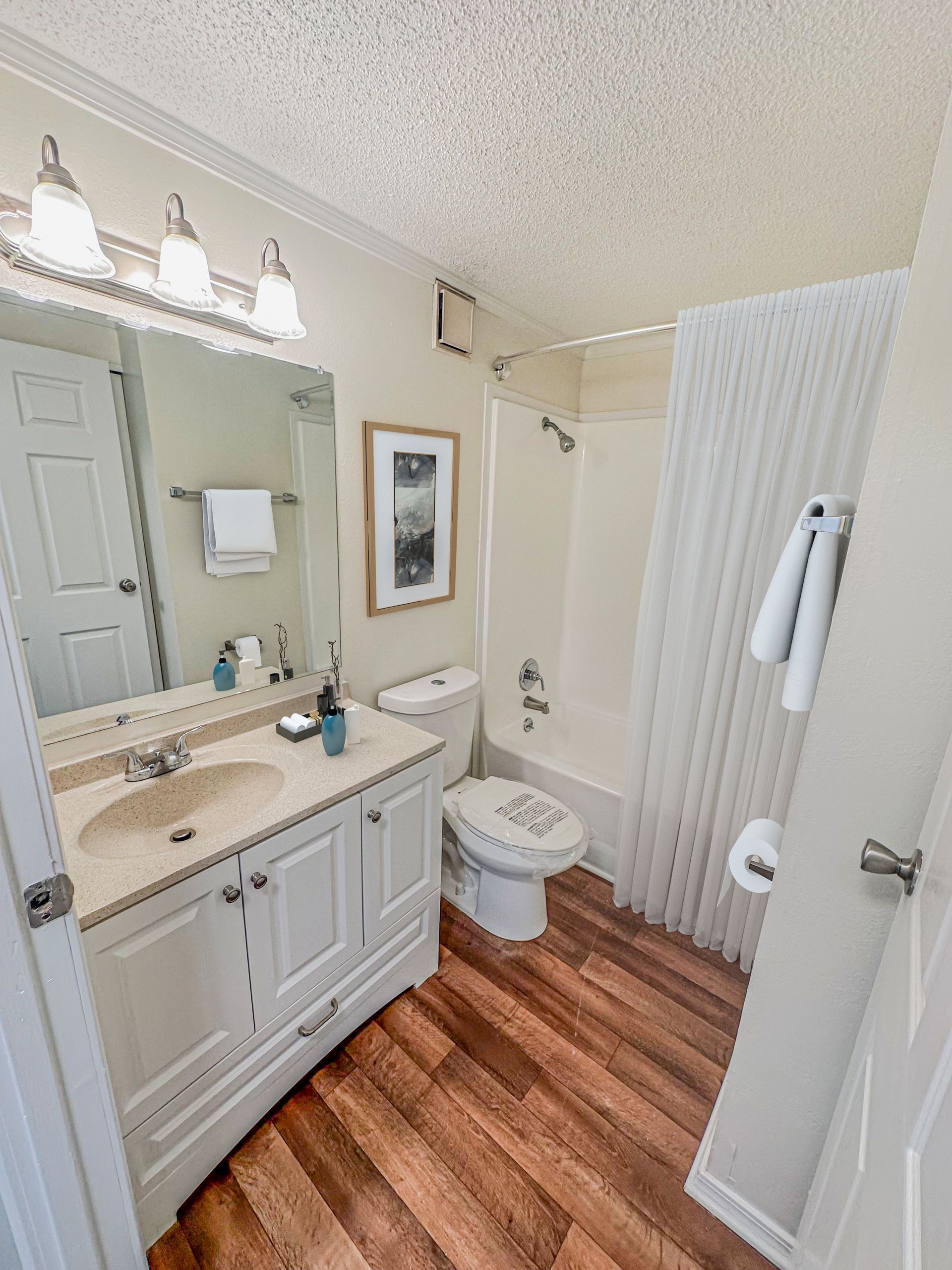 Photo of a bathroom showing a bathtub/shower combination