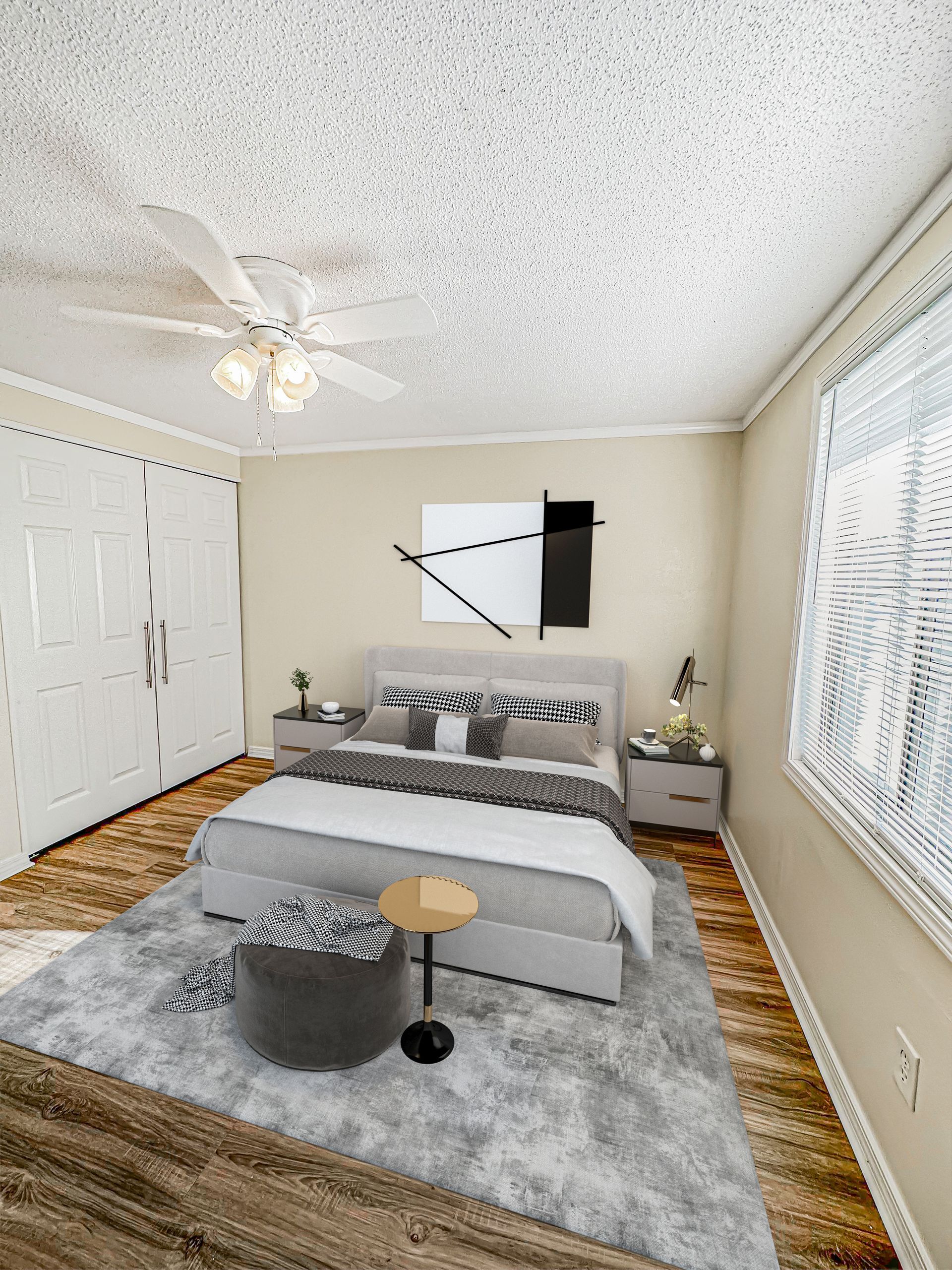 Photo of a bedroom, showing the bed, natural lighting from a large window, a ceiling fan, and a dual-door closet