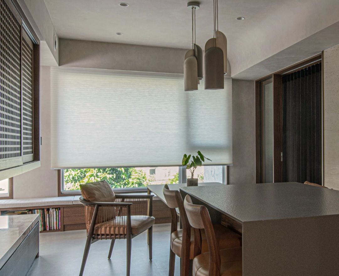 Dining room with a table, chairs, and a window with blinds.