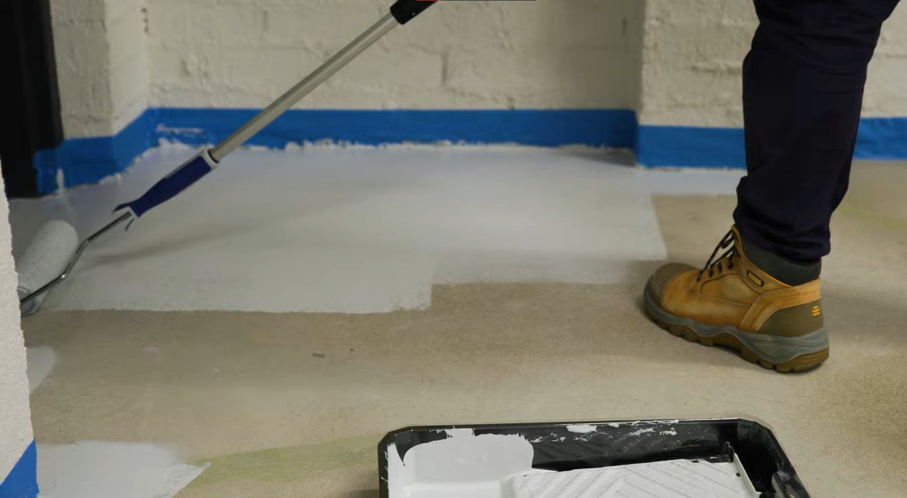 paint rolling white epoxy paint on floor