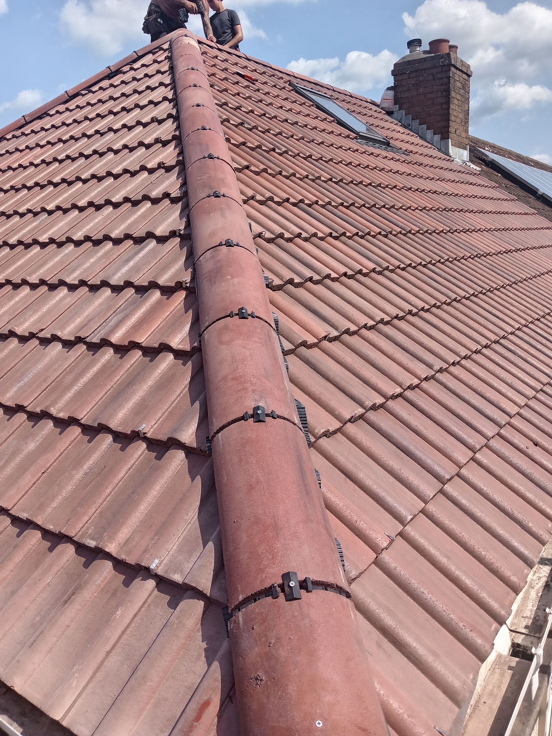 An aerial view of a tiled roof with houses in the background