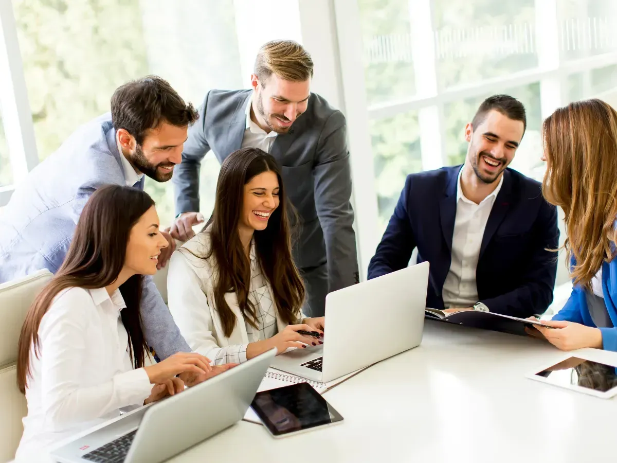 An insurance accounting team reviewing data together during AMS360 accounting training.