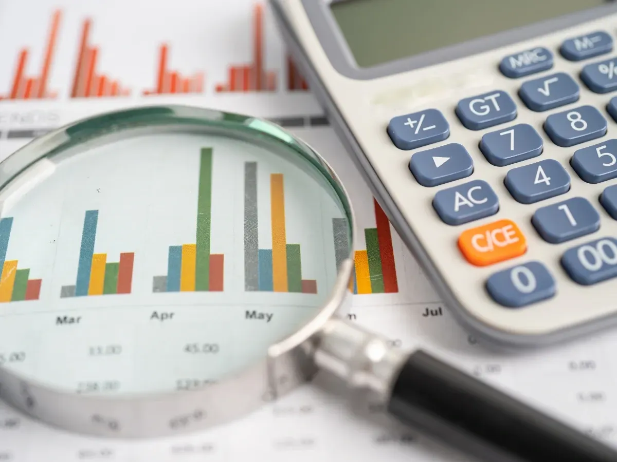 Graphs and calculator showing attention to detail, a key trait when choosing a financial advisor.