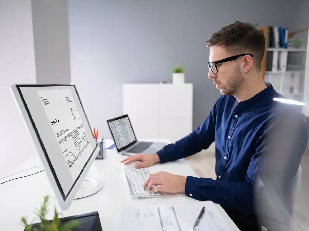 Insurance accountant analyzing digital invoices to generate key accounting insights for a firm.