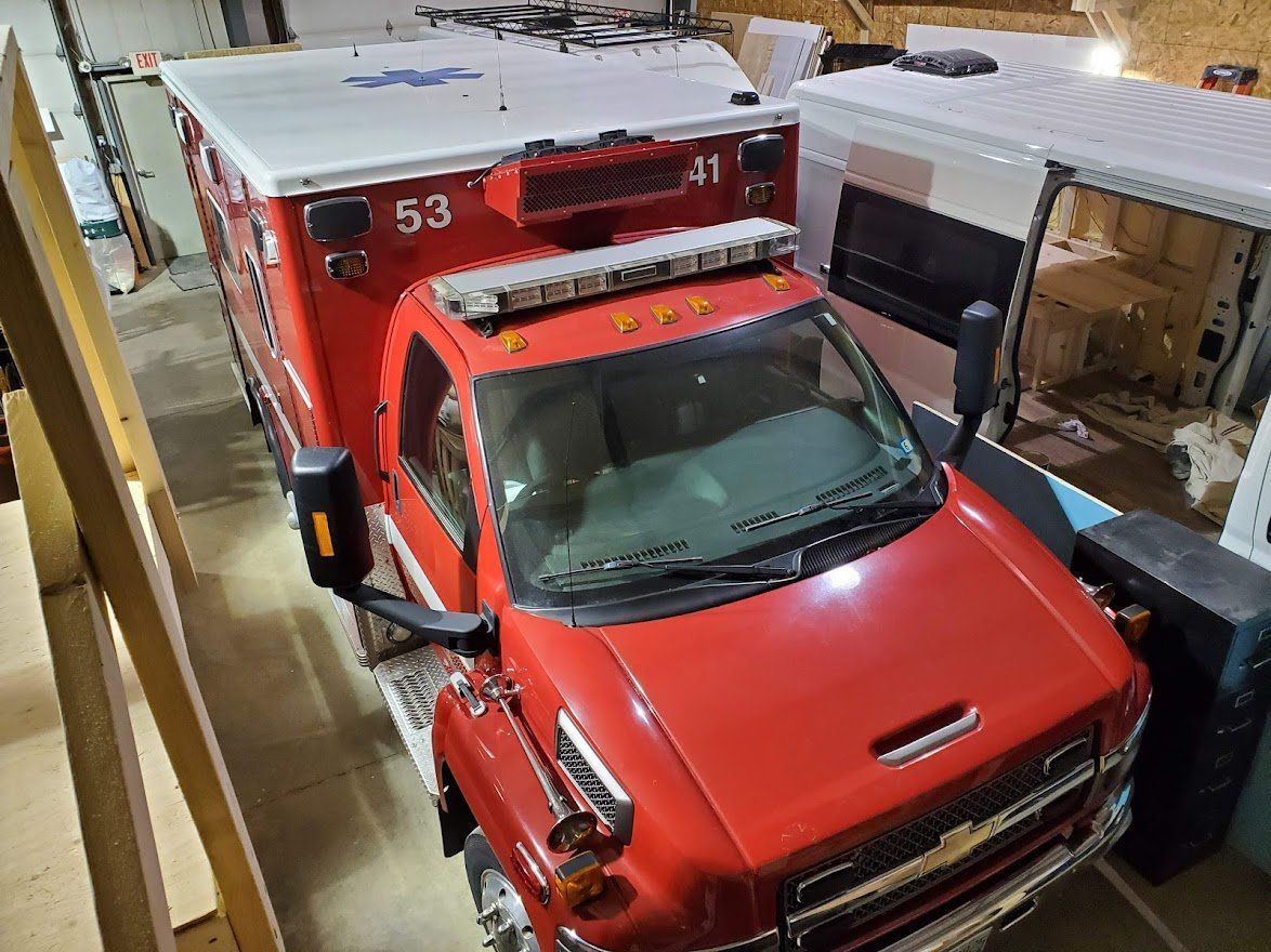 Red Ambulance Park In A Tight Position  - Milton, NH  - RV Service and R & L Van Builds