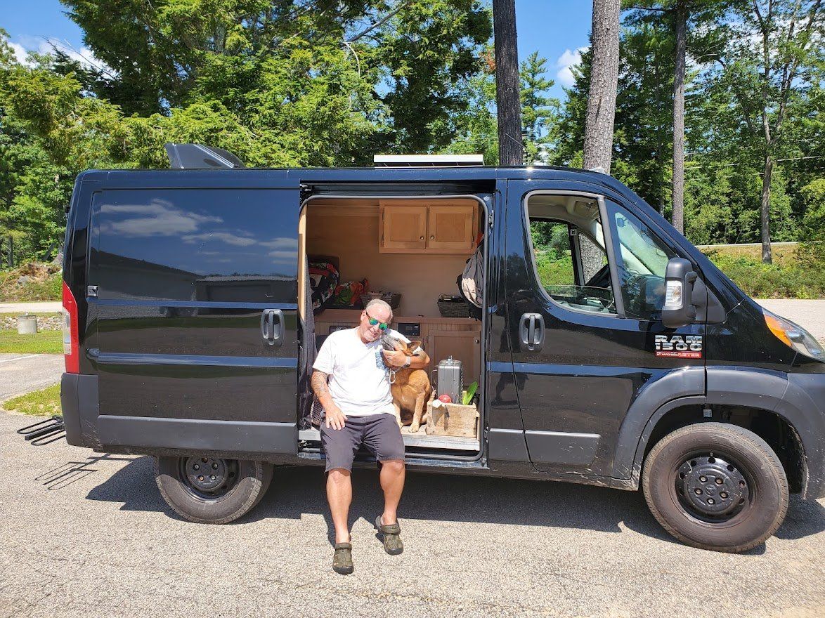 Man And Dog Sitting In A Camper Van - Milton, NH - RV Service and R & L Van Builds