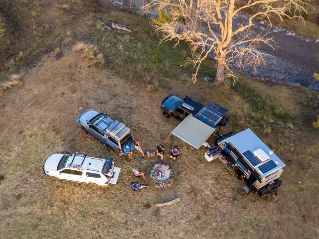 Aerial View of A Campsite with Four Trucks Parked Around a Fire Pit — Lacey's TJM 4X4 Megastore in Rockhampton City, QLD