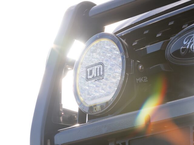 Close-Up of A Black Truck's Front Grill with A Large, Round Led Spotlight — Lacey's TJM 4X4 Megastore in Rockhampton City, QLD