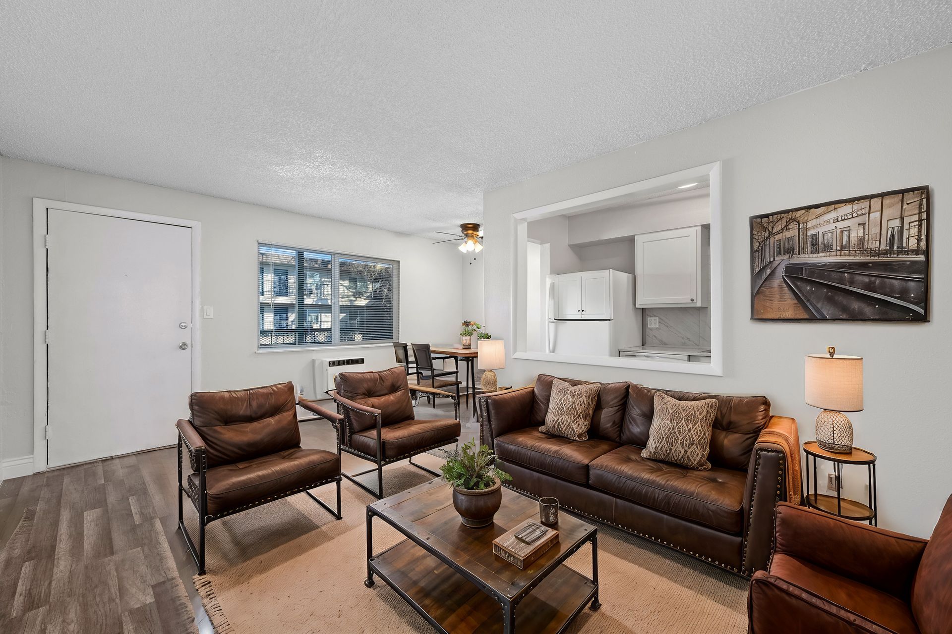 Photo of a living room with brown furniture and a long window
