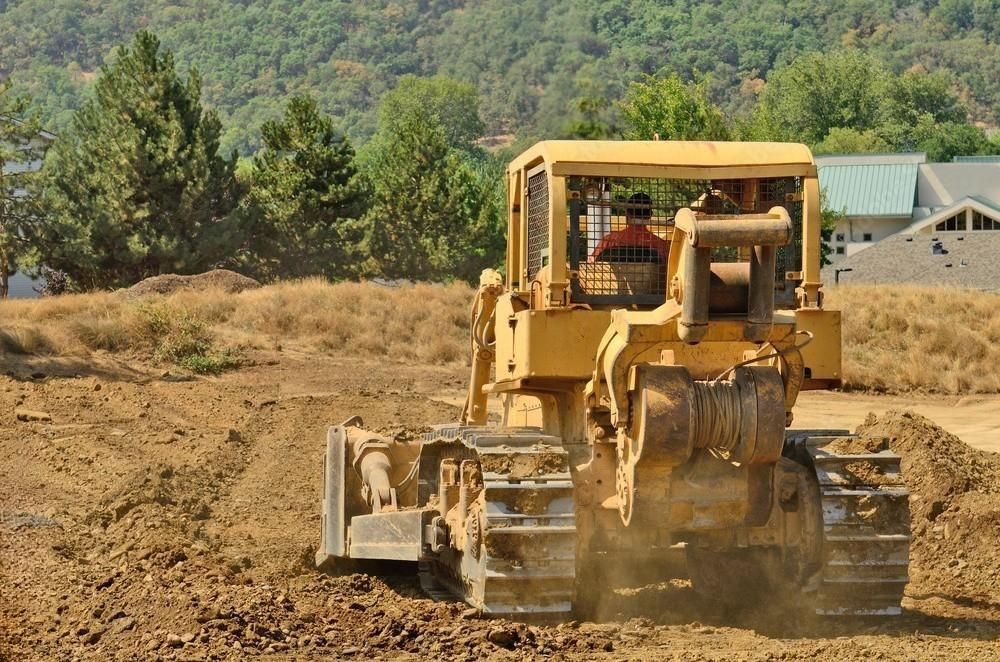 A bulldozer is moving dirt on a construction site