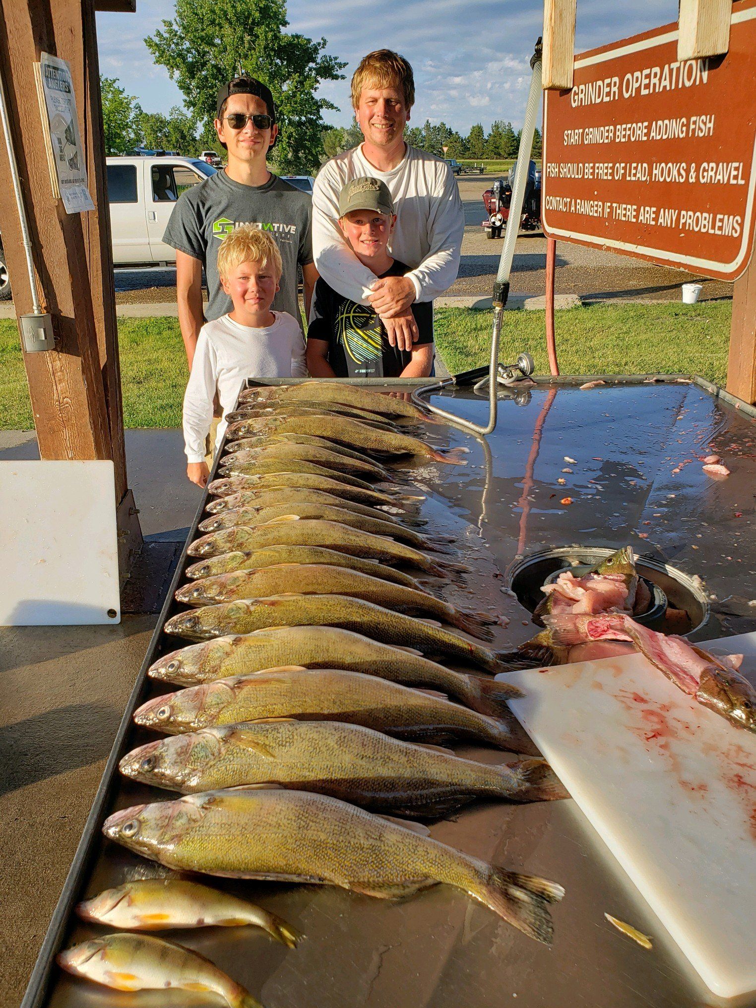 A group of people standing around a table full of fish.