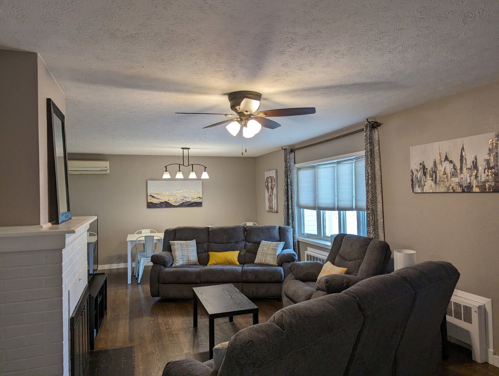 A living room filled with furniture and a ceiling fan.