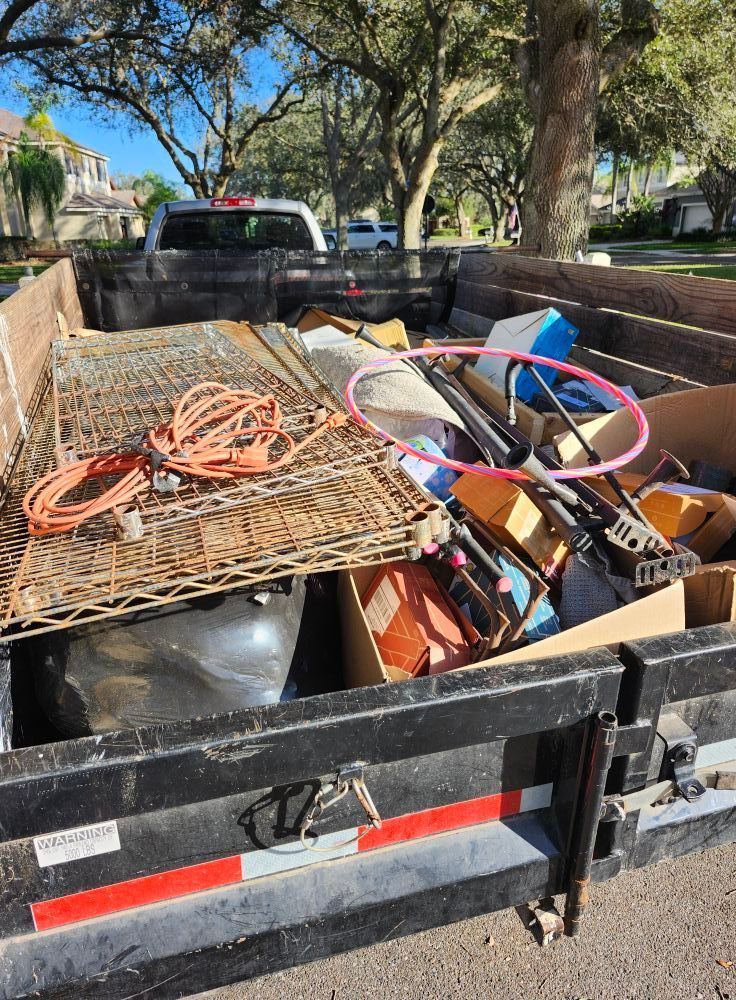 A man is giving a thumbs up in front of a garbage truck.