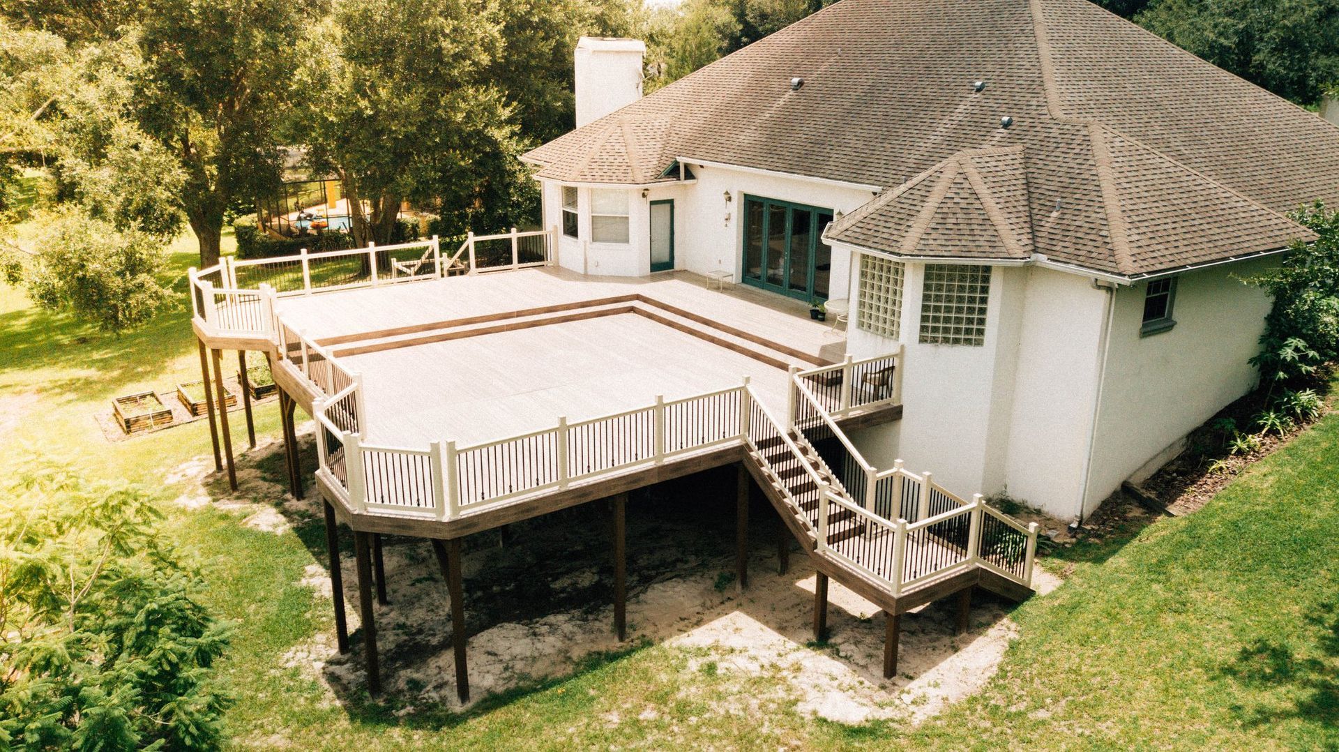 An aerial view of a house with a large deck