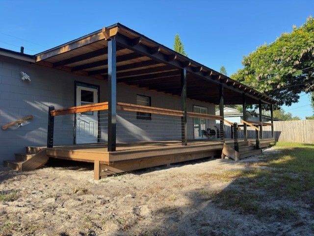 A house with a wooden deck and a covered porch