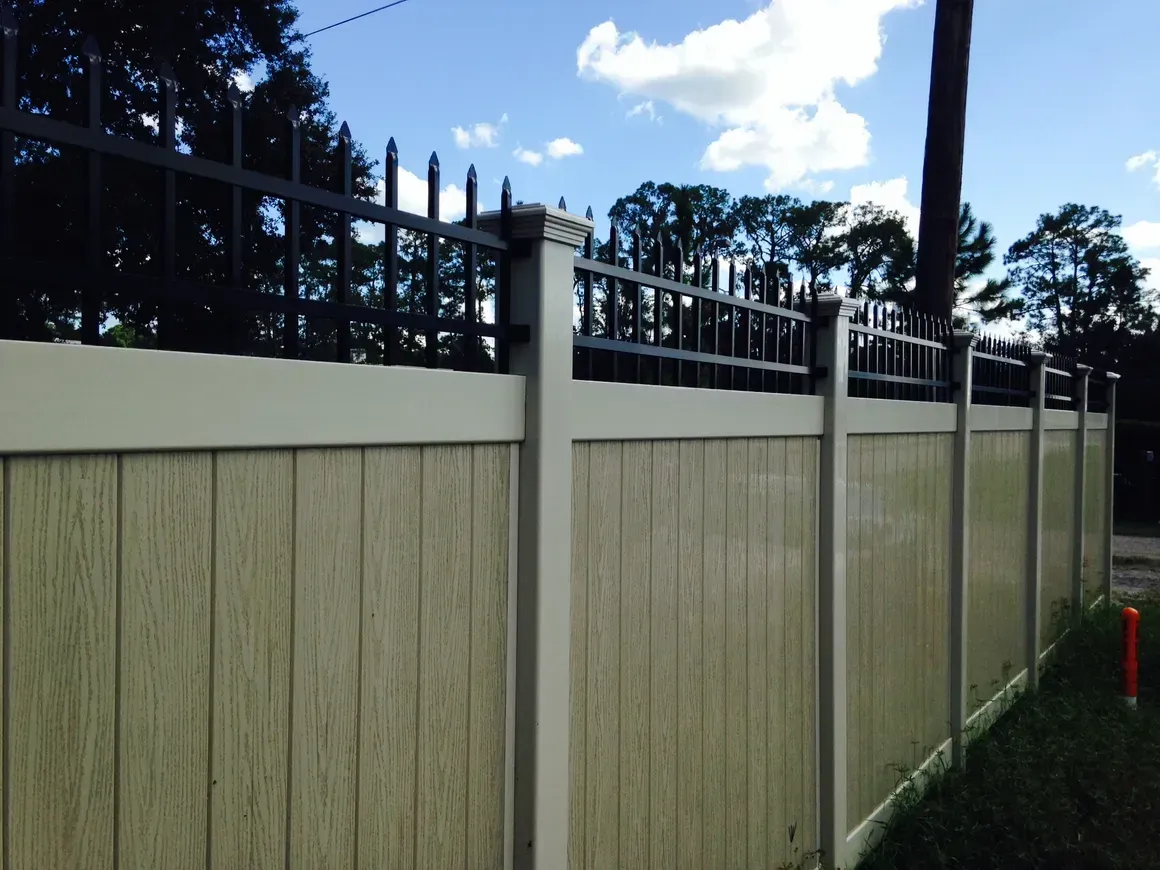 A wooden fence with a metal fence around it