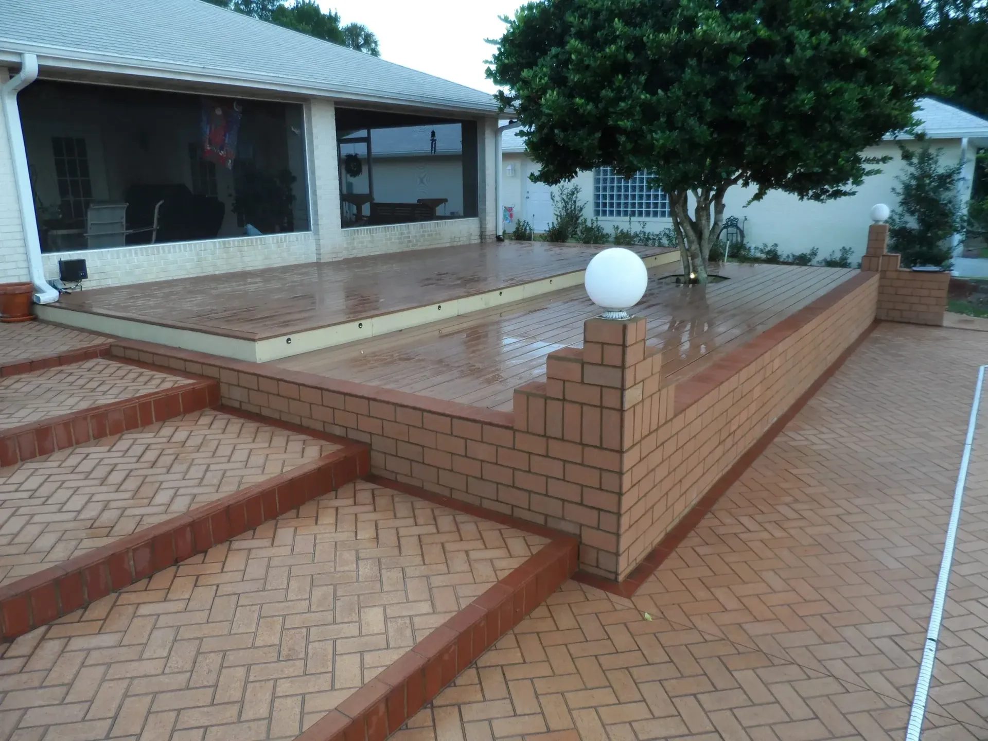 A brick walkway with stairs leading up to a house