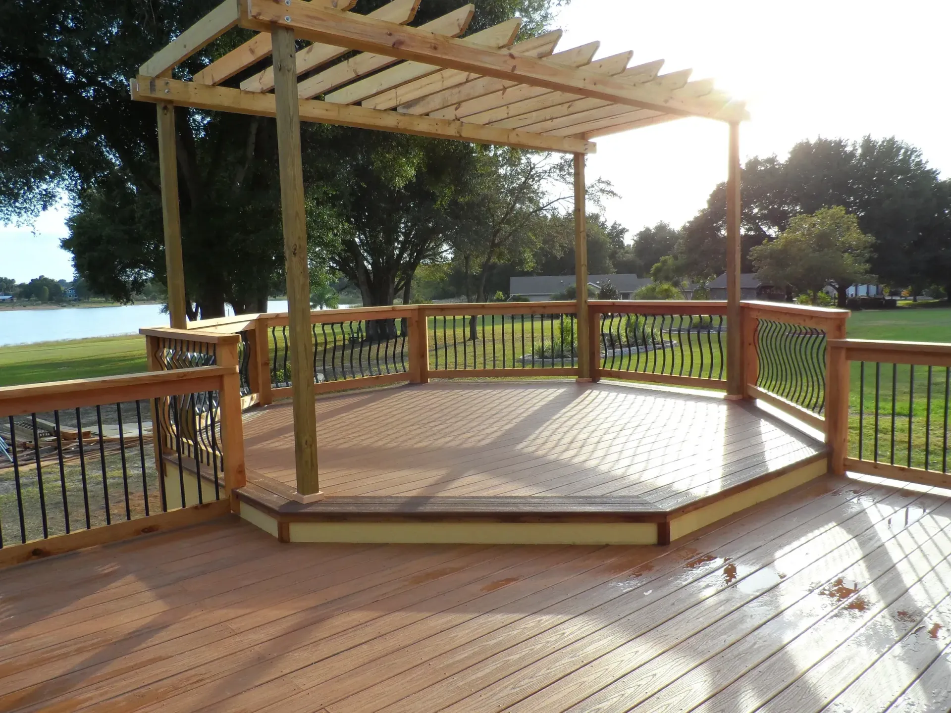A wooden deck with a pergola on top of it