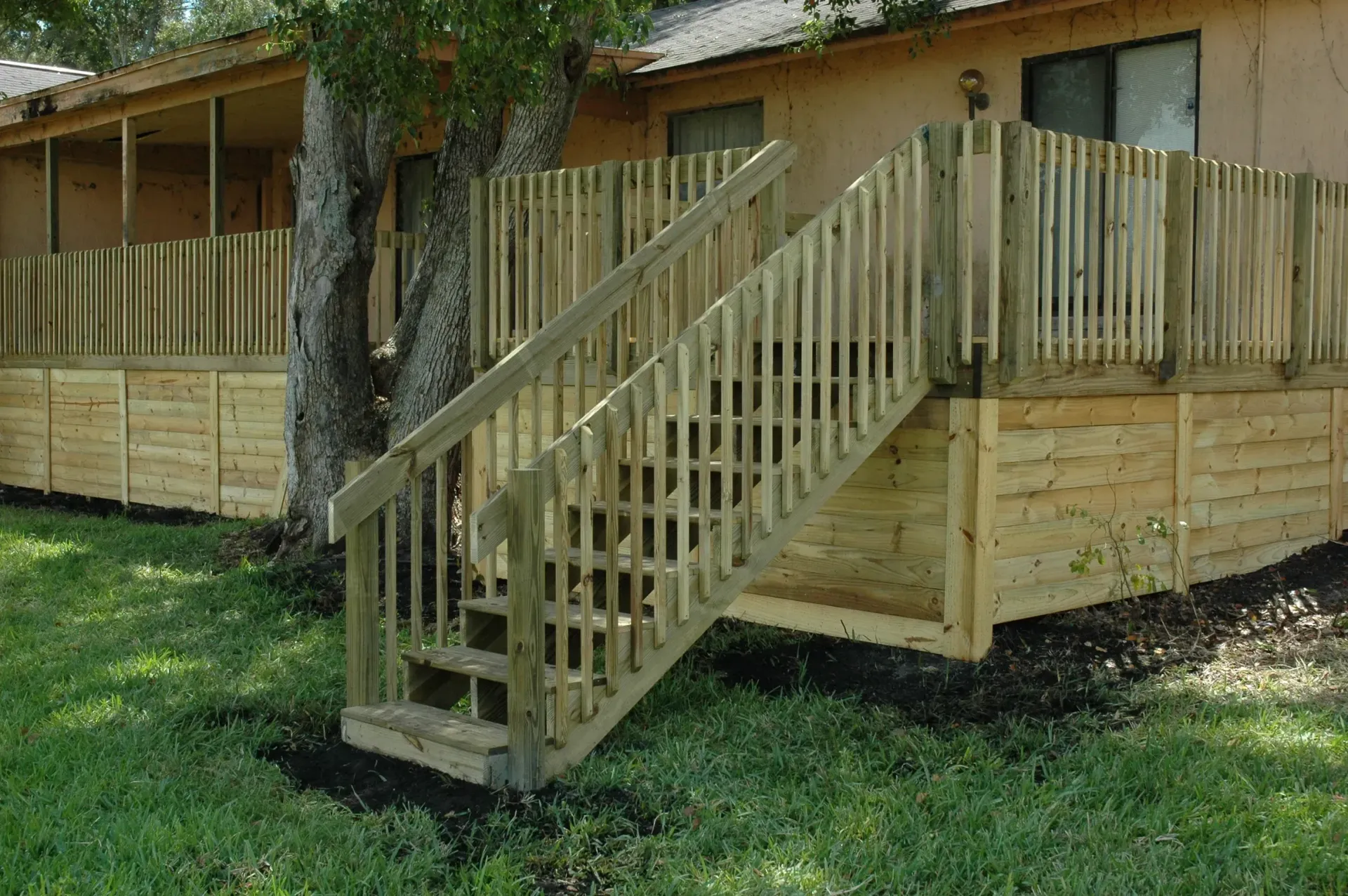 A wooden deck with stairs leading up to it