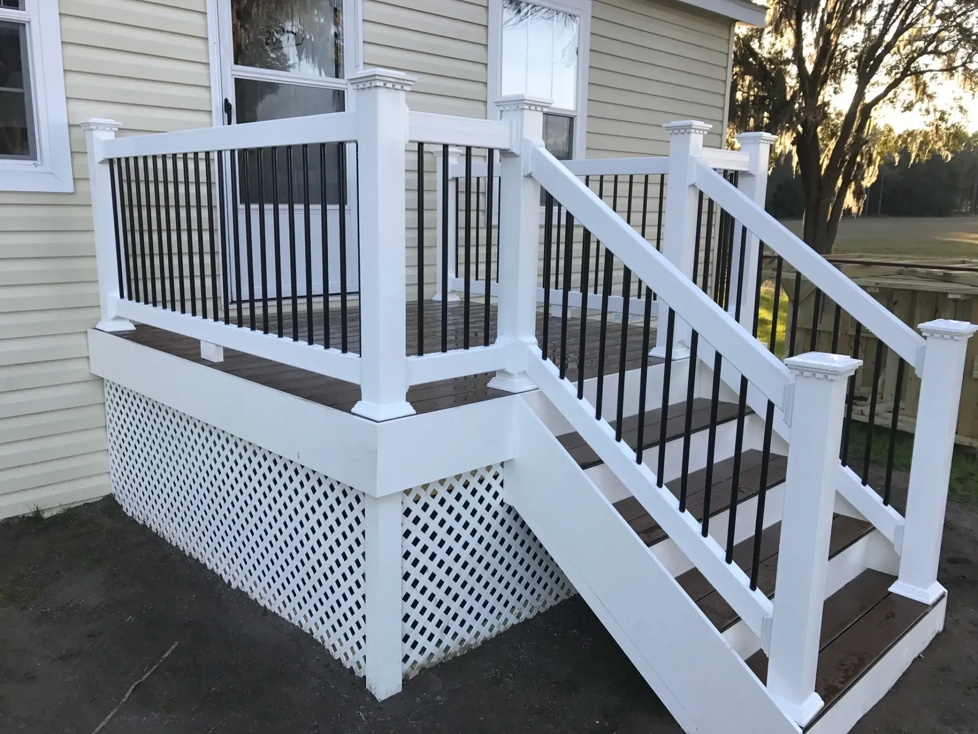 A white deck with stairs leading up to it