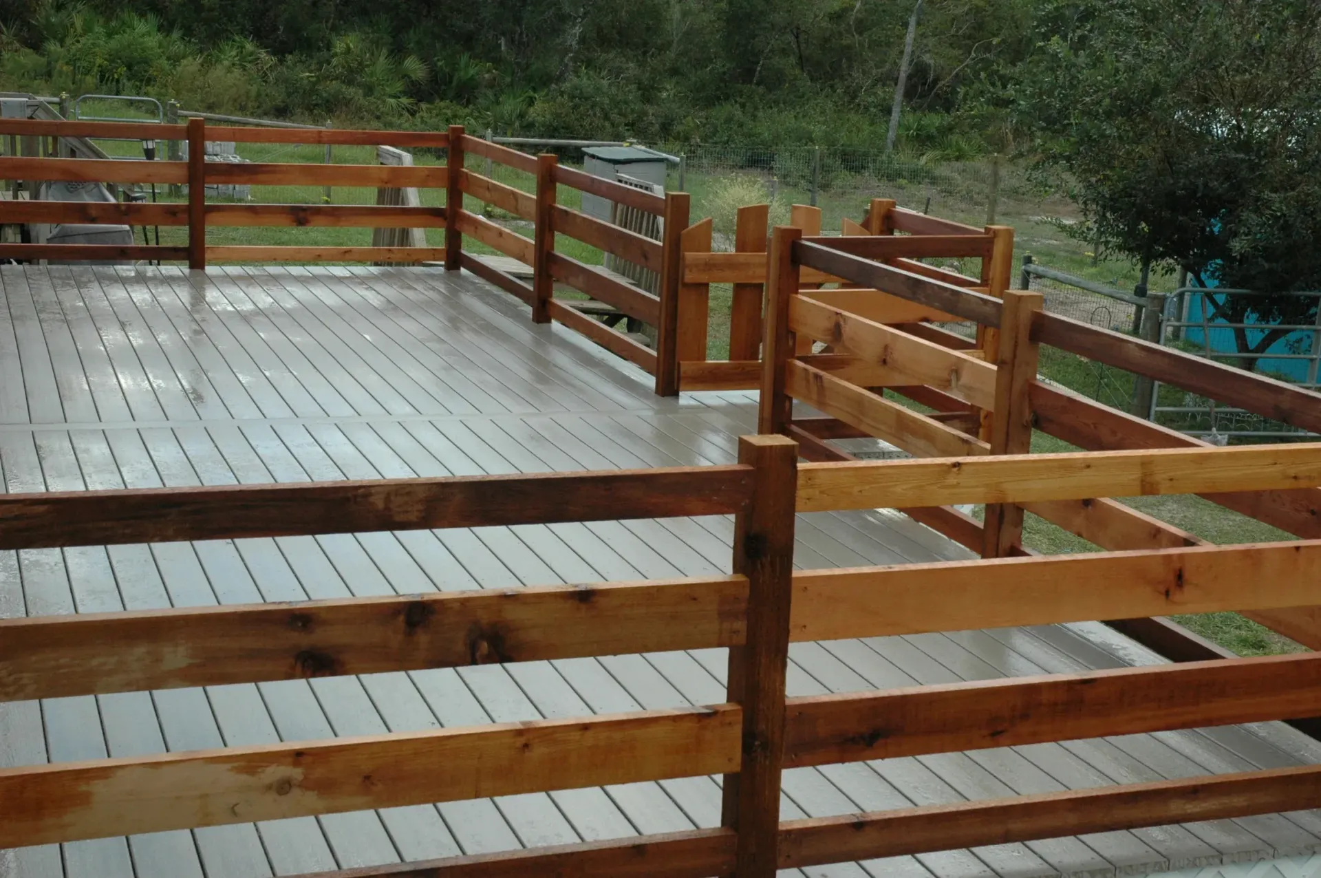 A wooden deck with a wooden fence around it