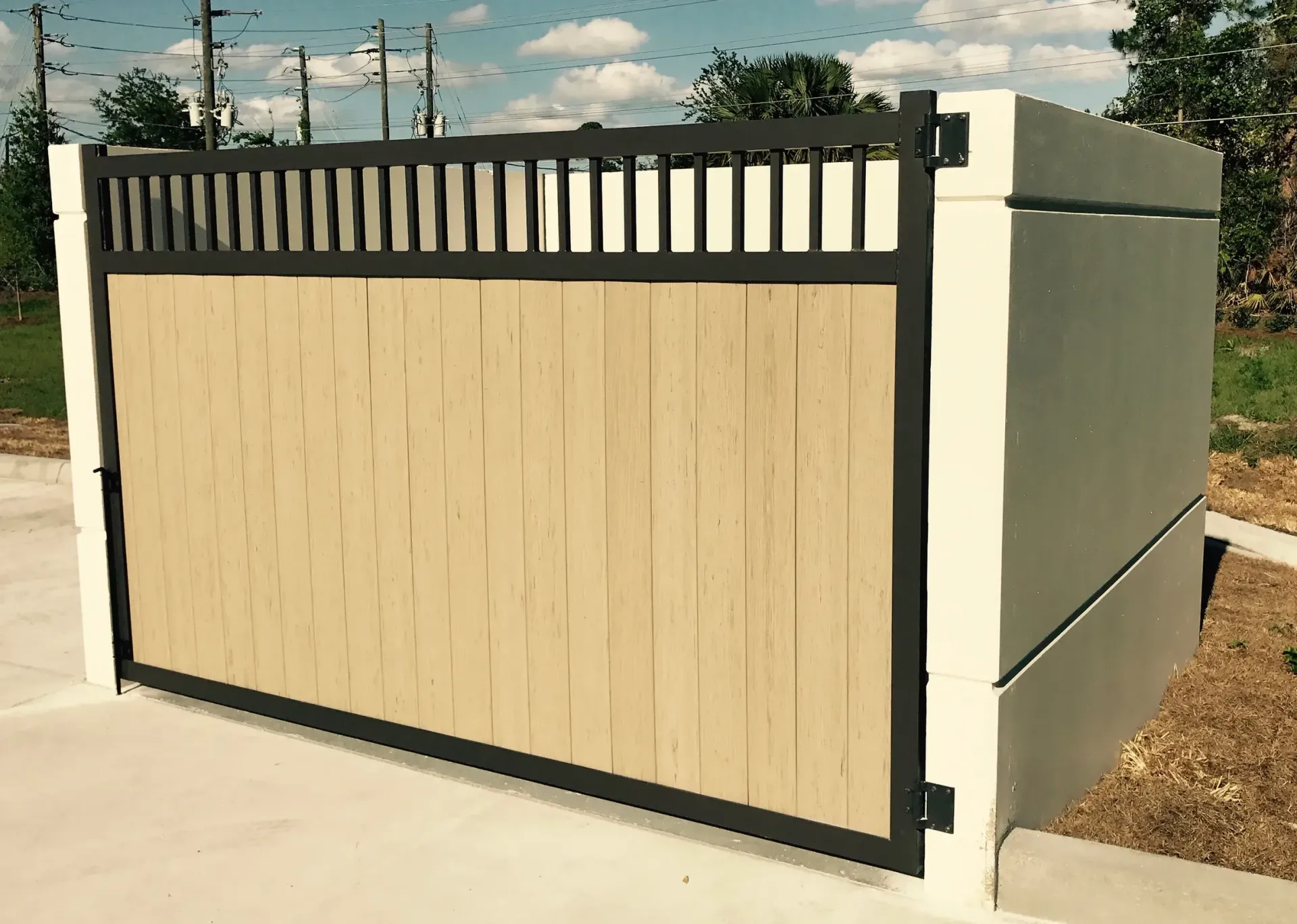 A fence with a wooden panel and a metal frame