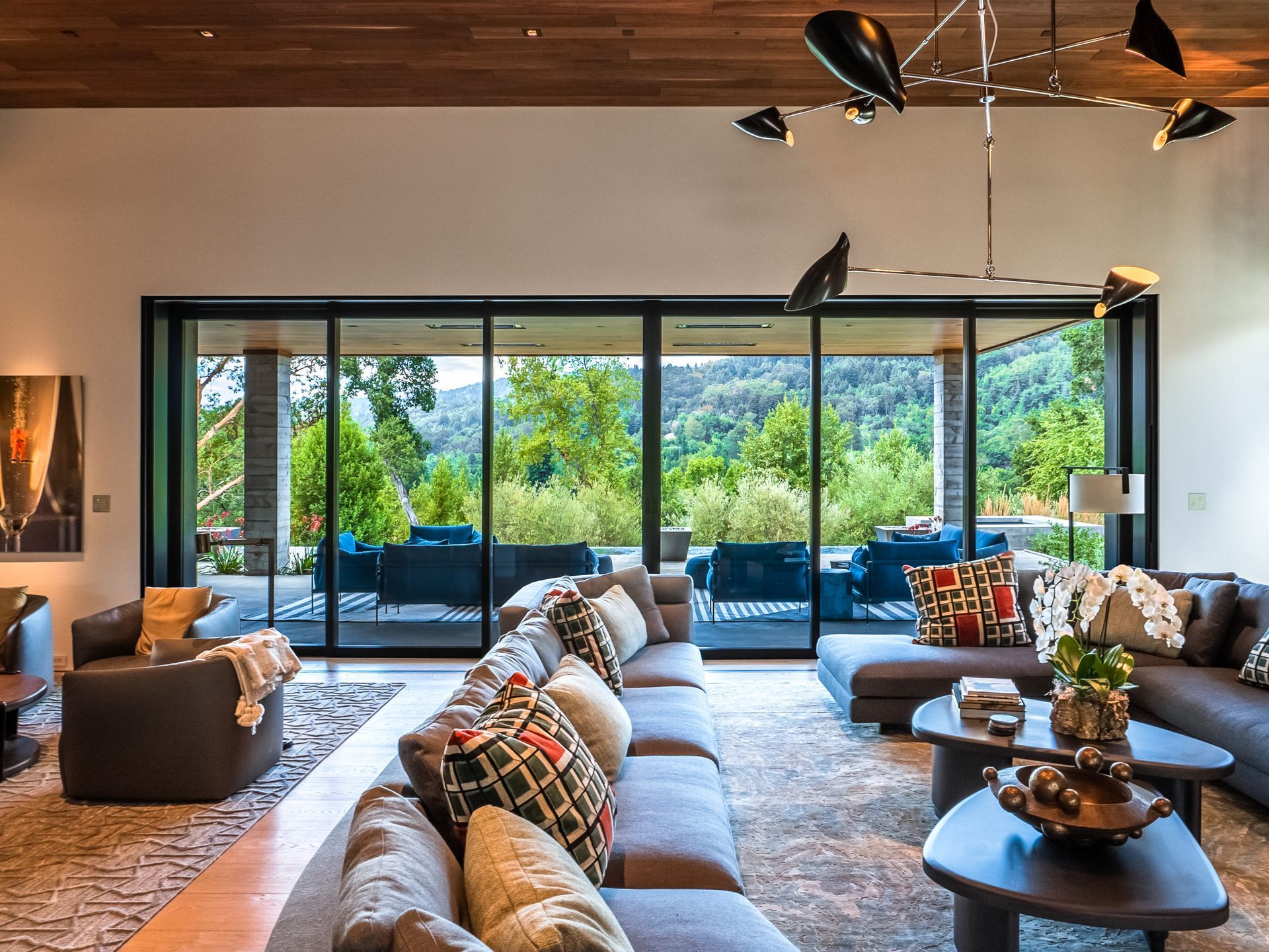 A living room with a lot of furniture and sliding glass doors