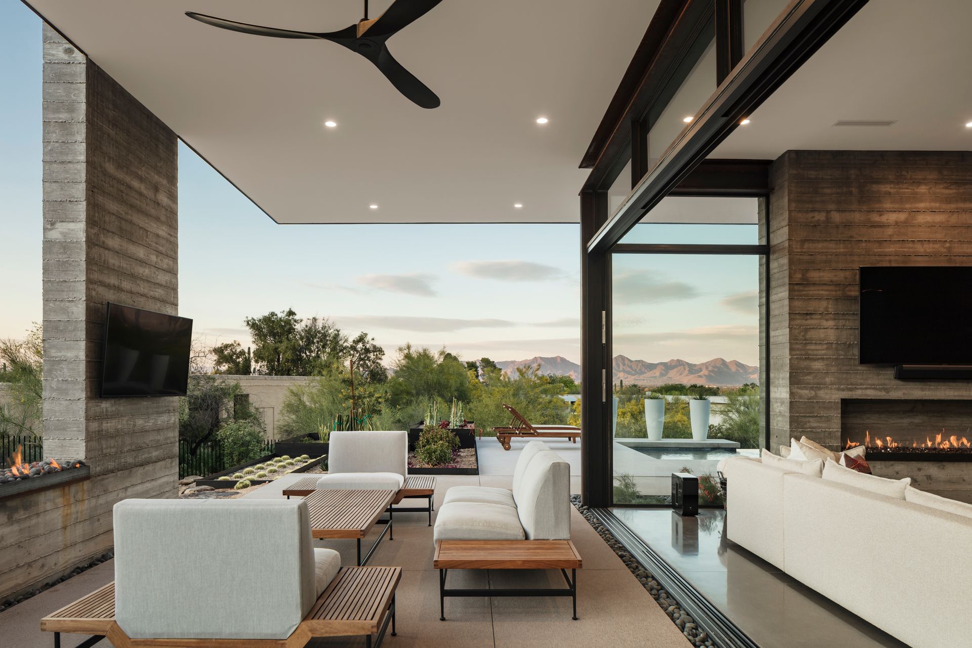 A living room with a fireplace and a ceiling fan