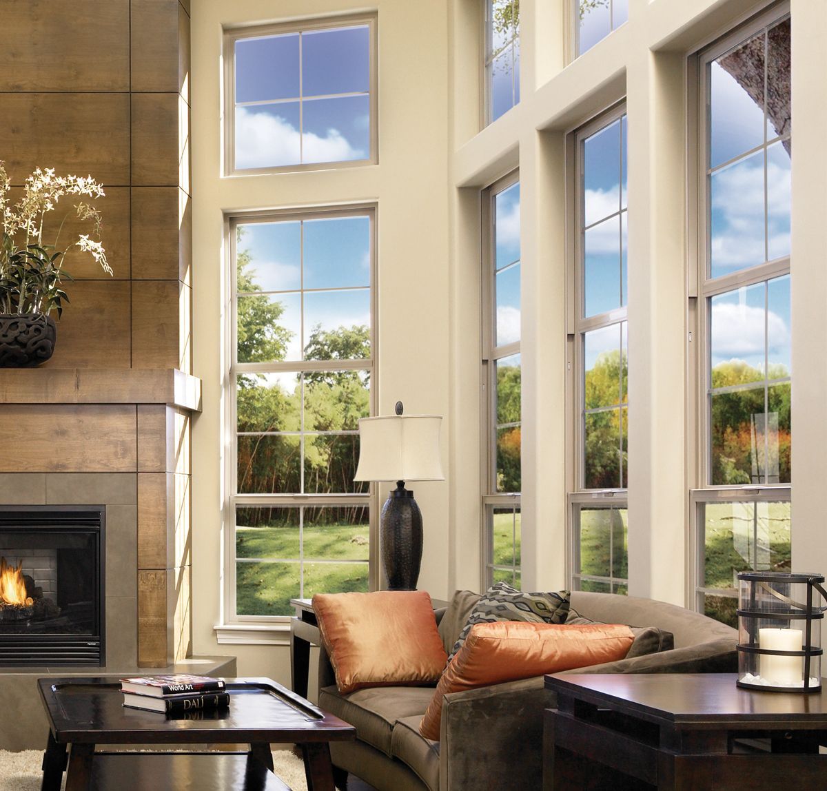 A living room with a fireplace and lots of windows