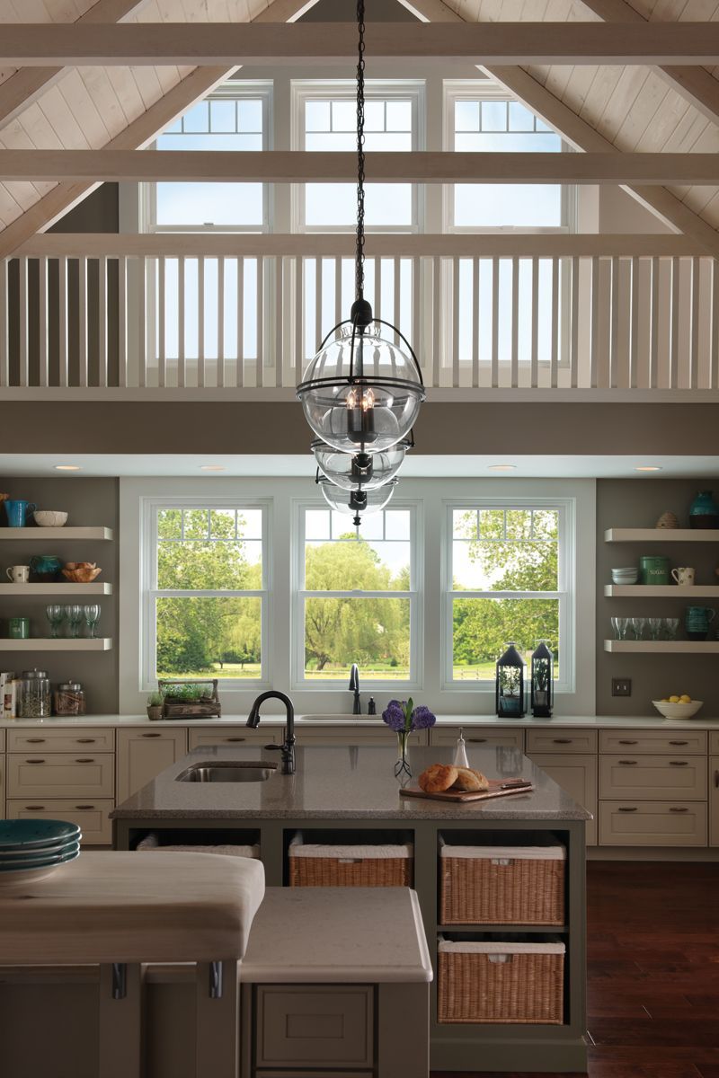 A kitchen with a lot of windows and a chandelier hanging from the ceiling.