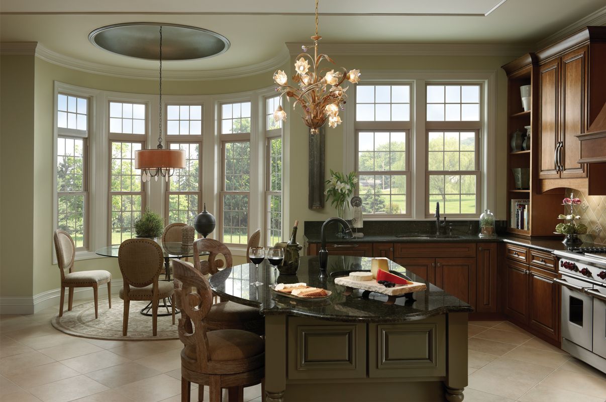 A kitchen with a large island and lots of windows
