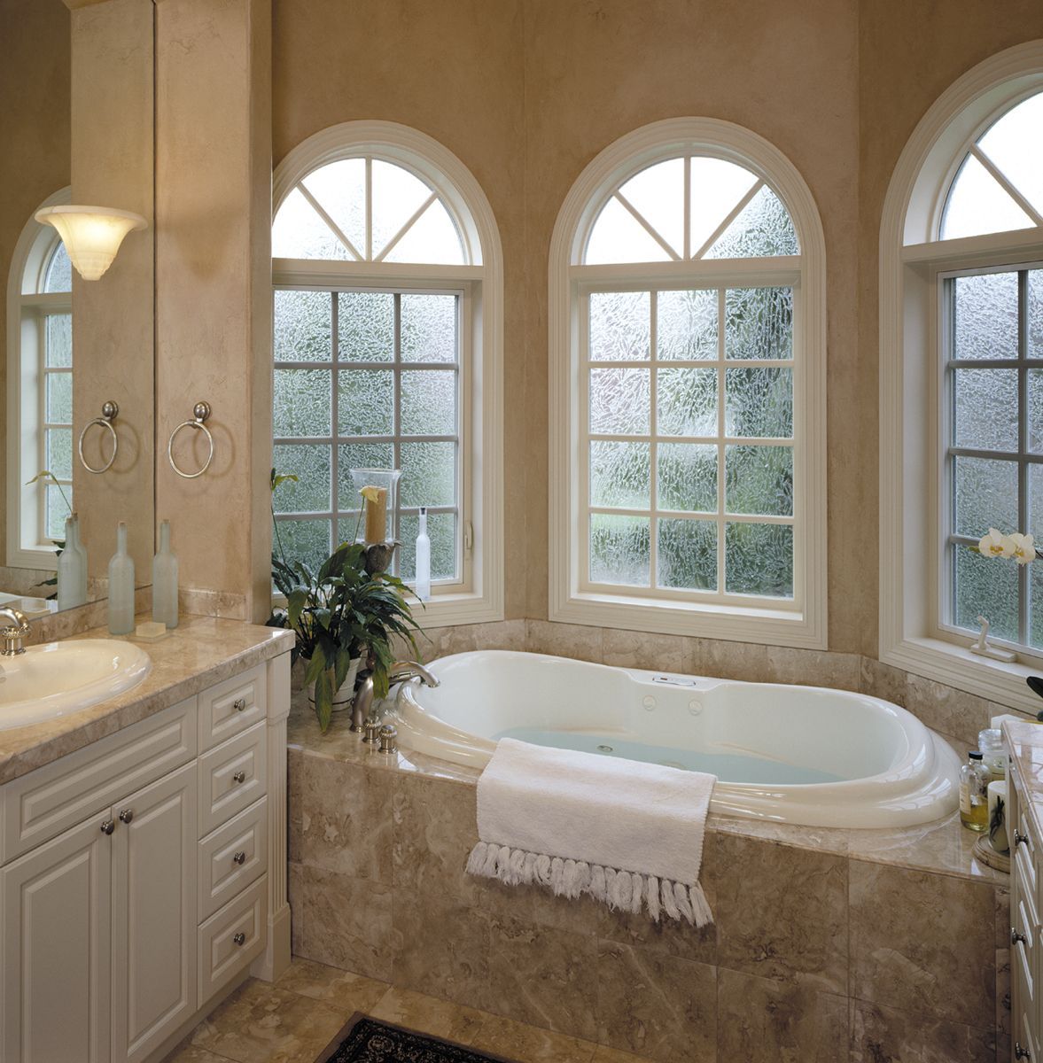 A bathroom with a bathtub and two windows