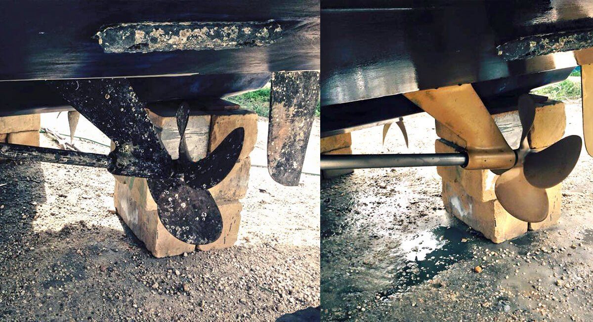 A boat propeller is sitting on a wooden block.