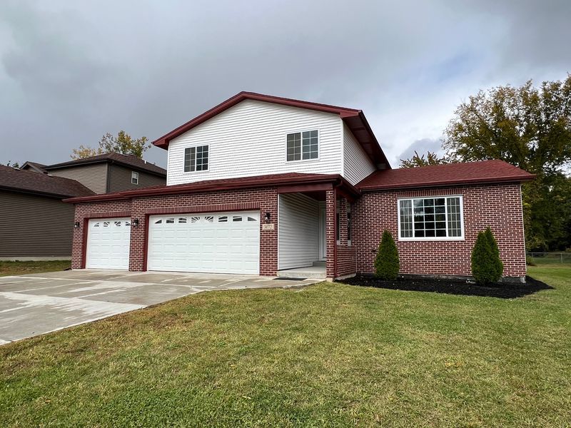 A large brick house with a white garage door