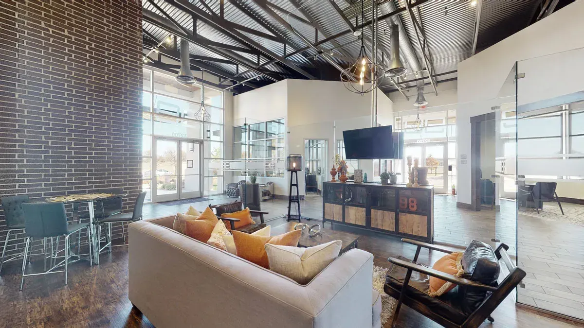 Resident lounge with a couch , chairs and a television.