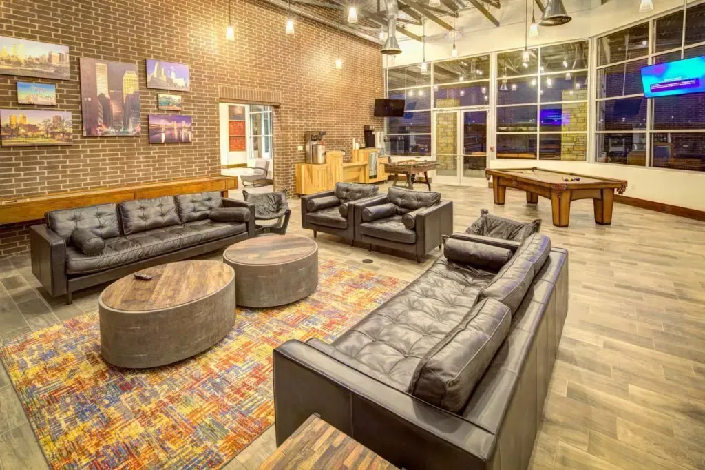 Clubhouse filled with furniture and a pool table.