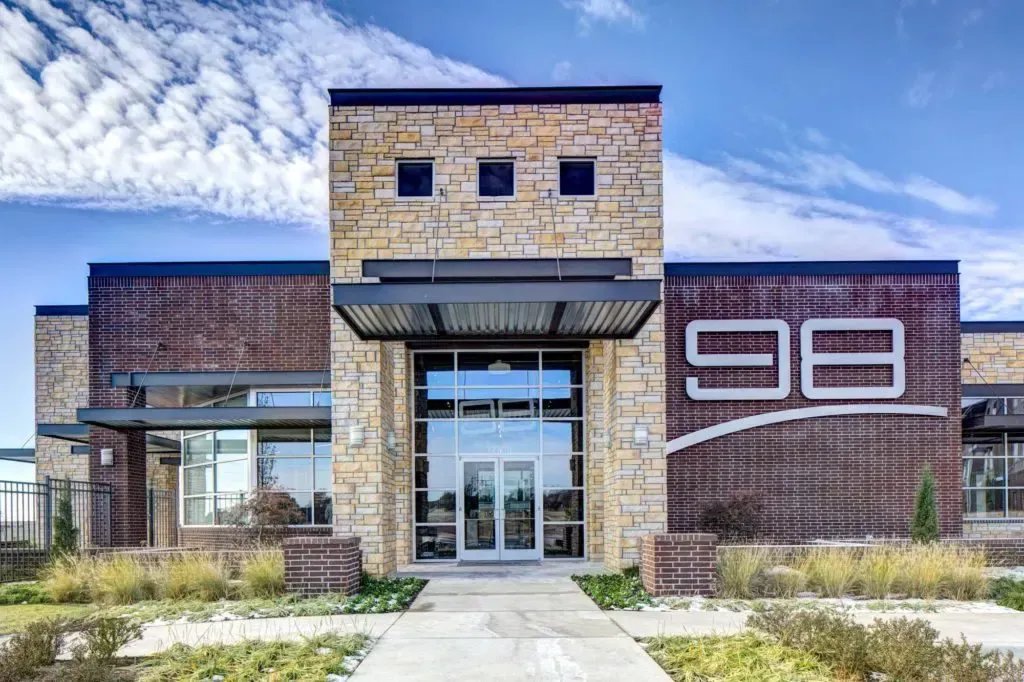 A large brick building with the number 98 on it