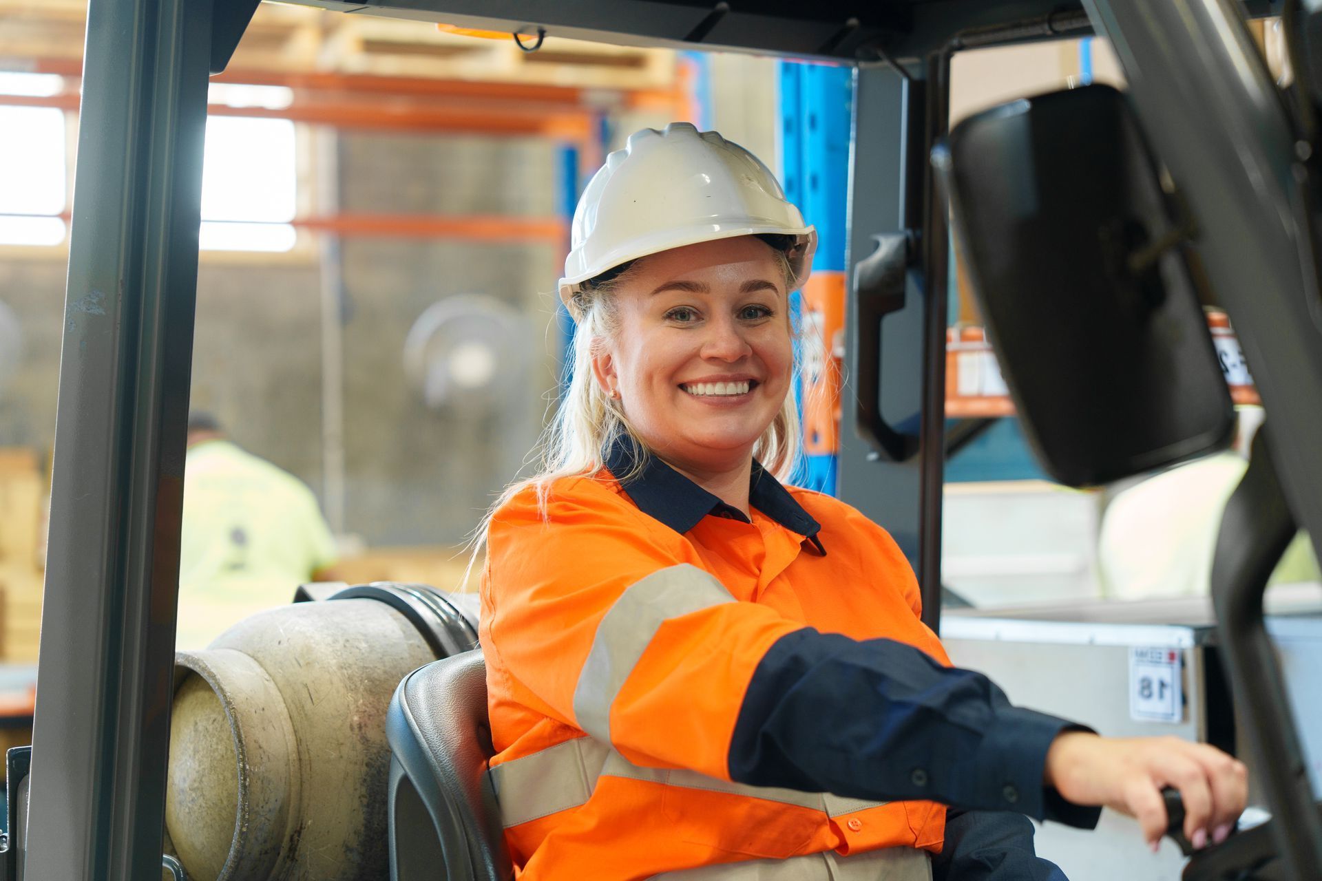 A man in a wheelchair is sitting on a park bench talking to another man.