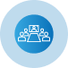 A group of people sitting around a table in a blue circle.