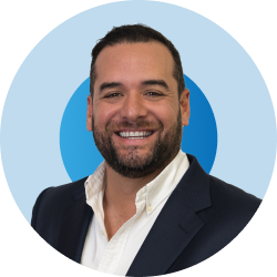 A man with a beard is smiling in a blue circle