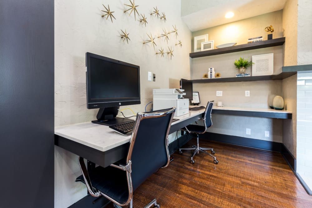Community business center with a desk, chairs, computer, and printer at Marquis at Legacy in Plano, TX.