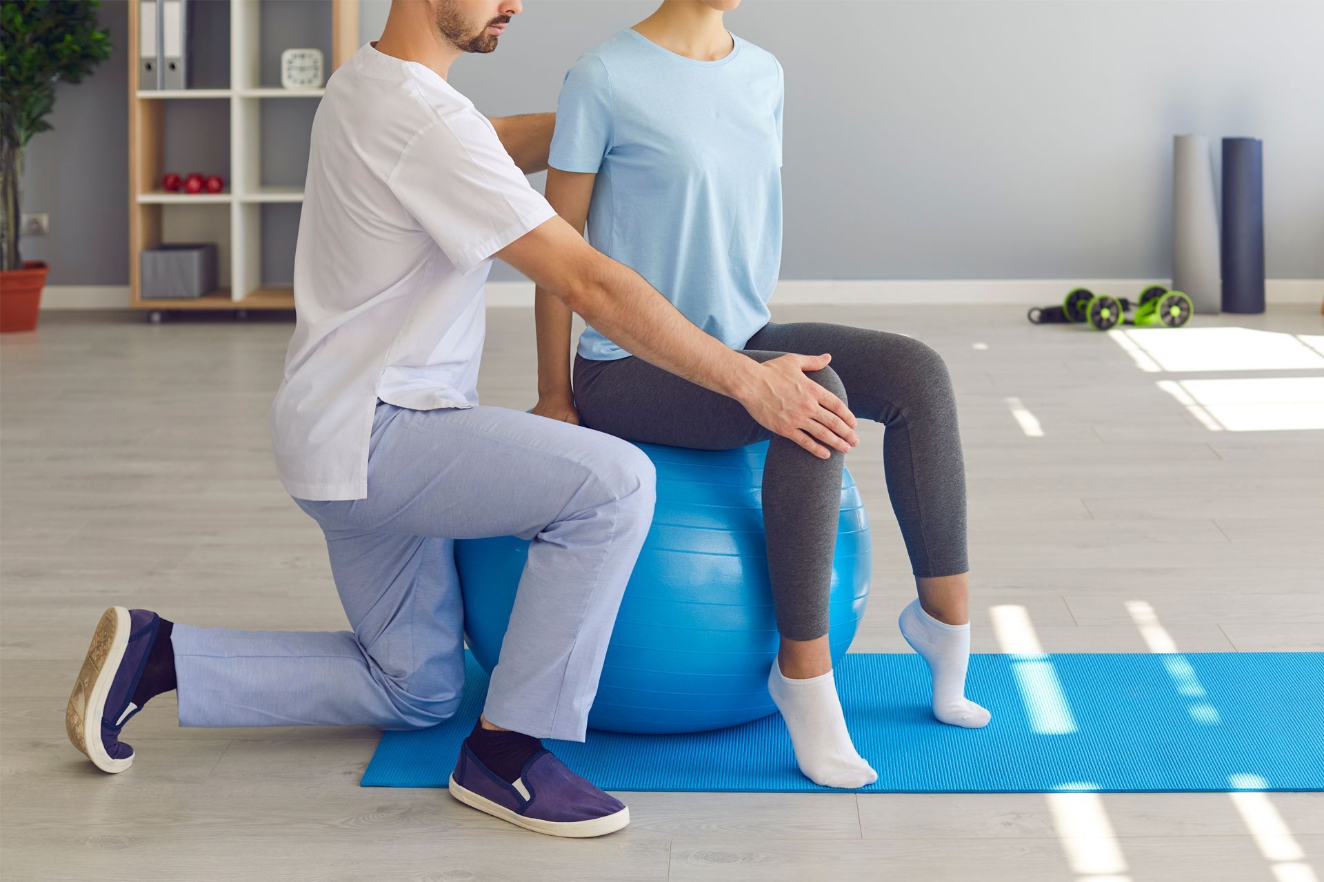 Assisting a Woman's to Sit on Balance Ball