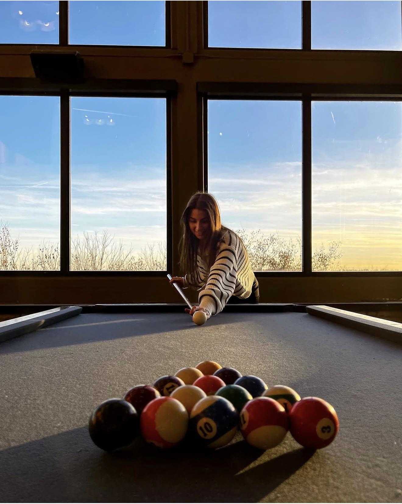 University of Iowa students relaxing and chatting over drinks  in Iowa City near their fully furnished apartment.
