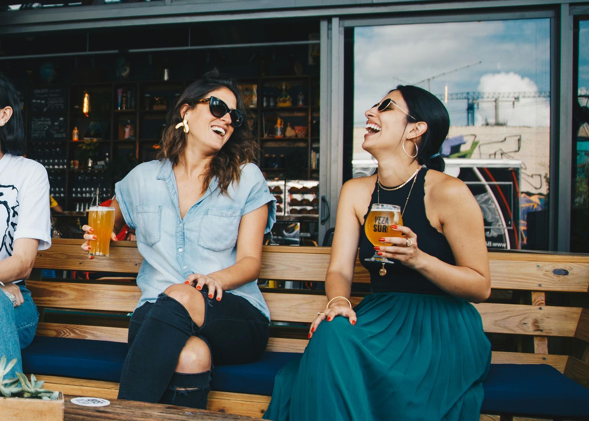 University of Iowa students relaxing and chatting over drinks  in Iowa City near their fully furnished apartment.