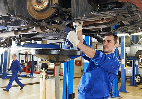 Mechanic Fixing Engine Under the Car — North Providence, RI — Town Line Service & Towing