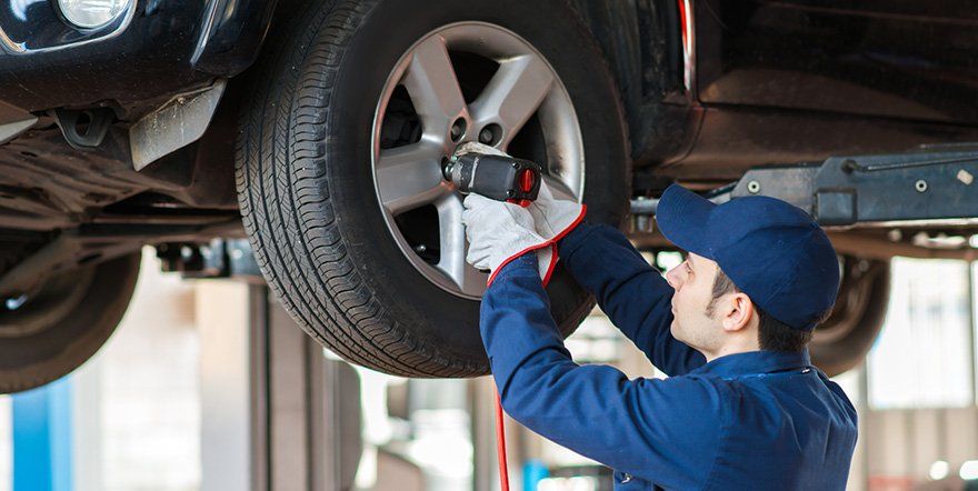 Mechanic Fixing Wheel — North Providence, RI — Town Line Service & Towing