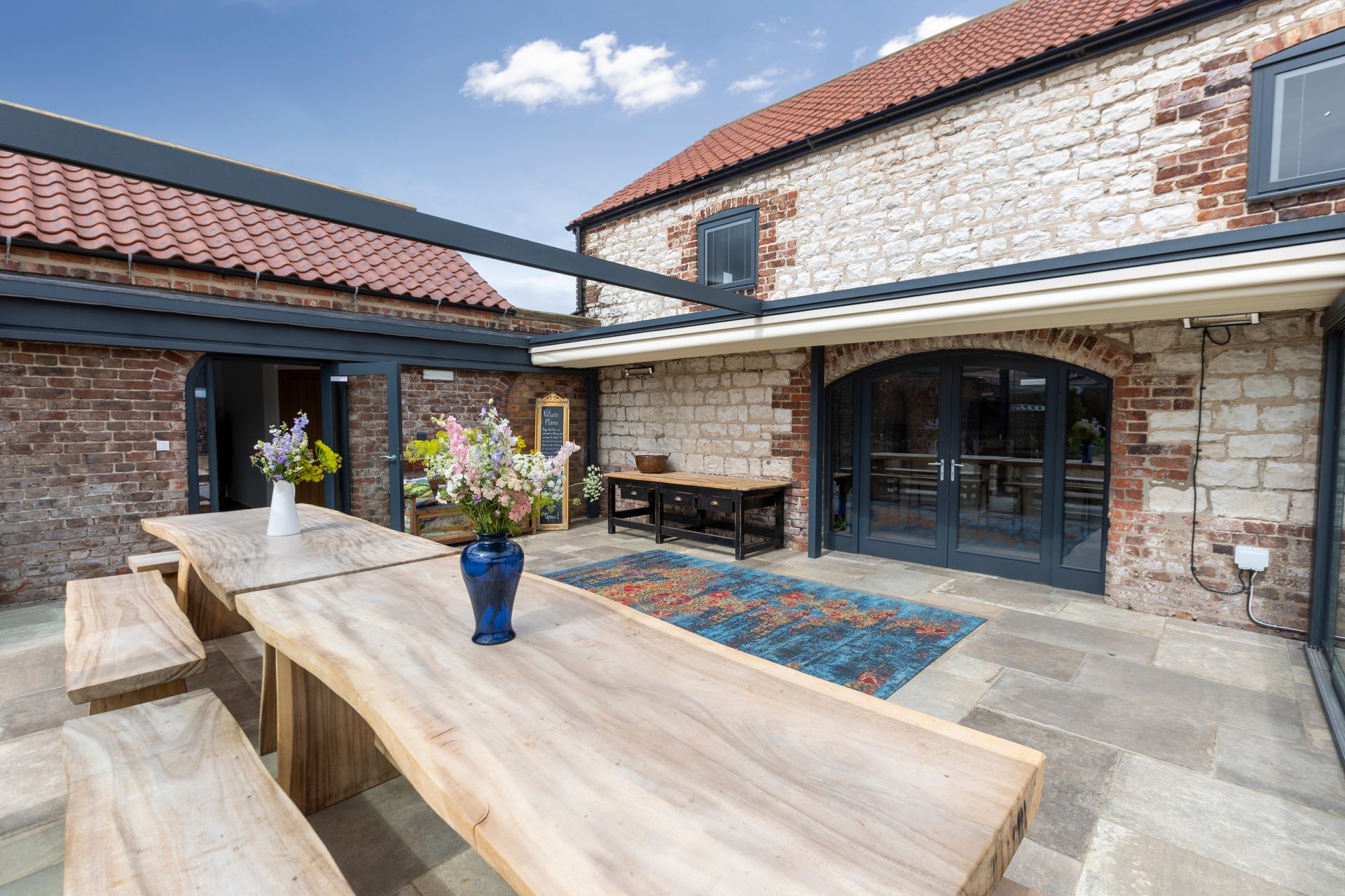 A large hot tub is sitting in a room next to a window.