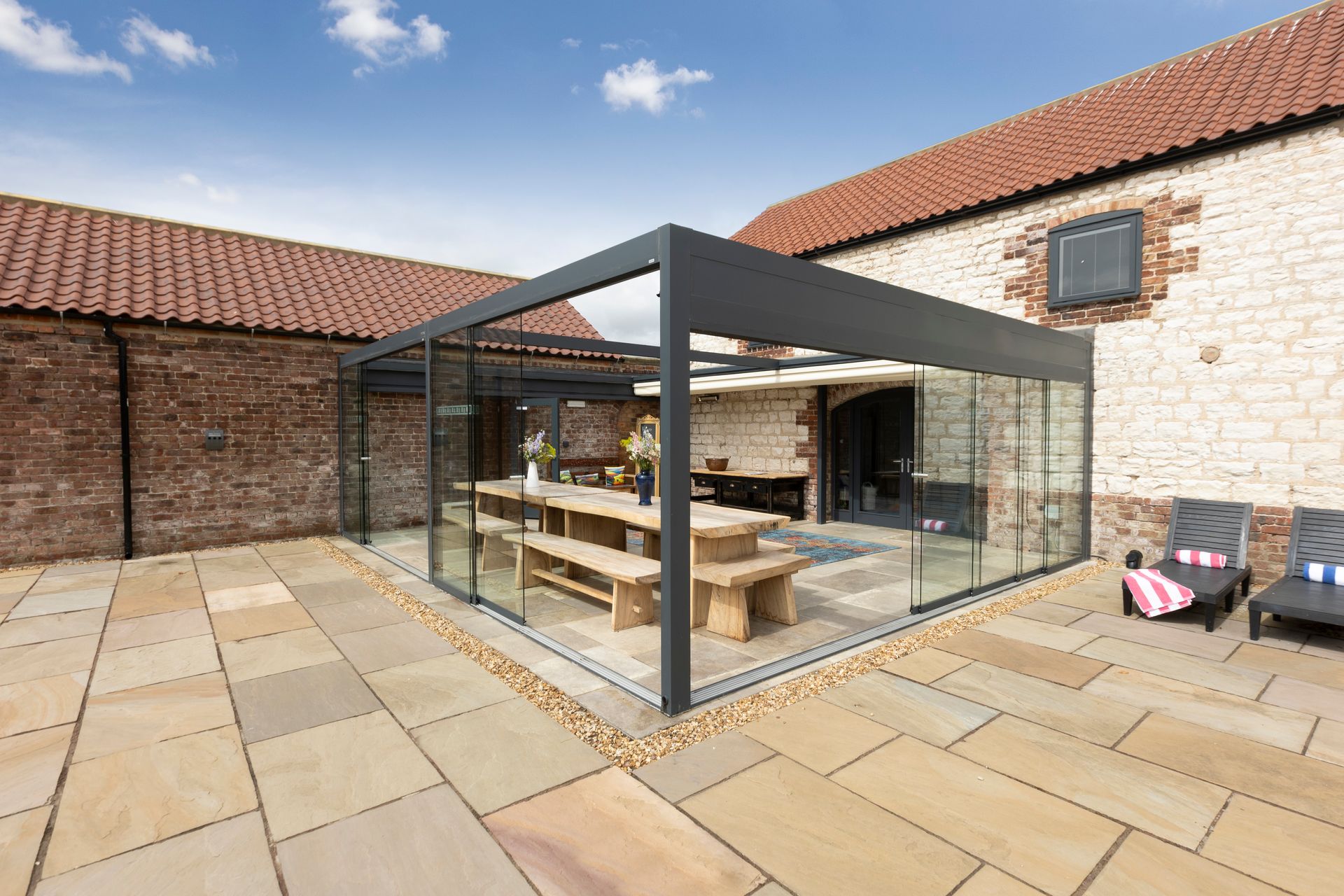 A bedroom with a bed , chair , television and blue walls.