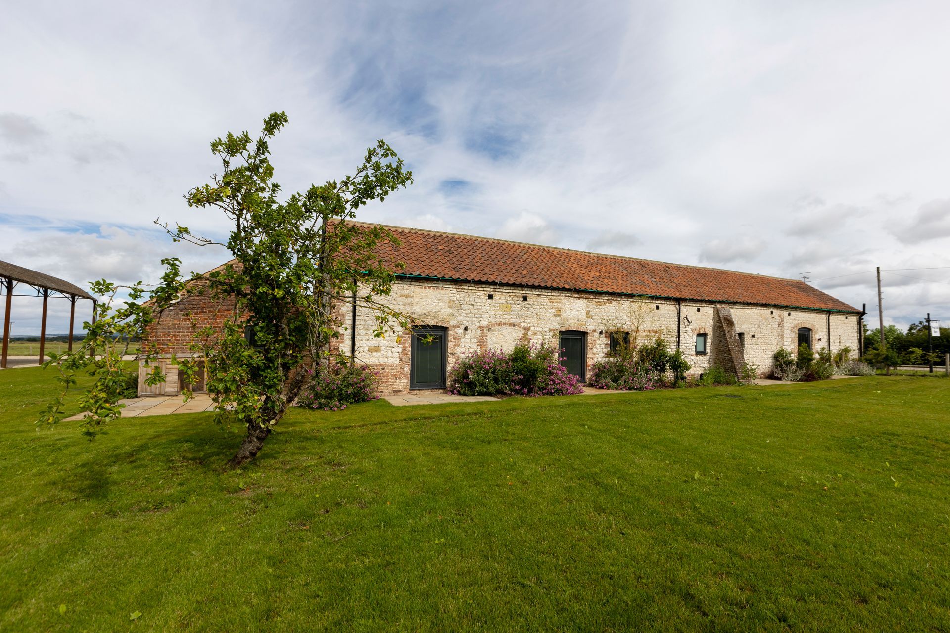 A dining room with a long wooden table and chairs
