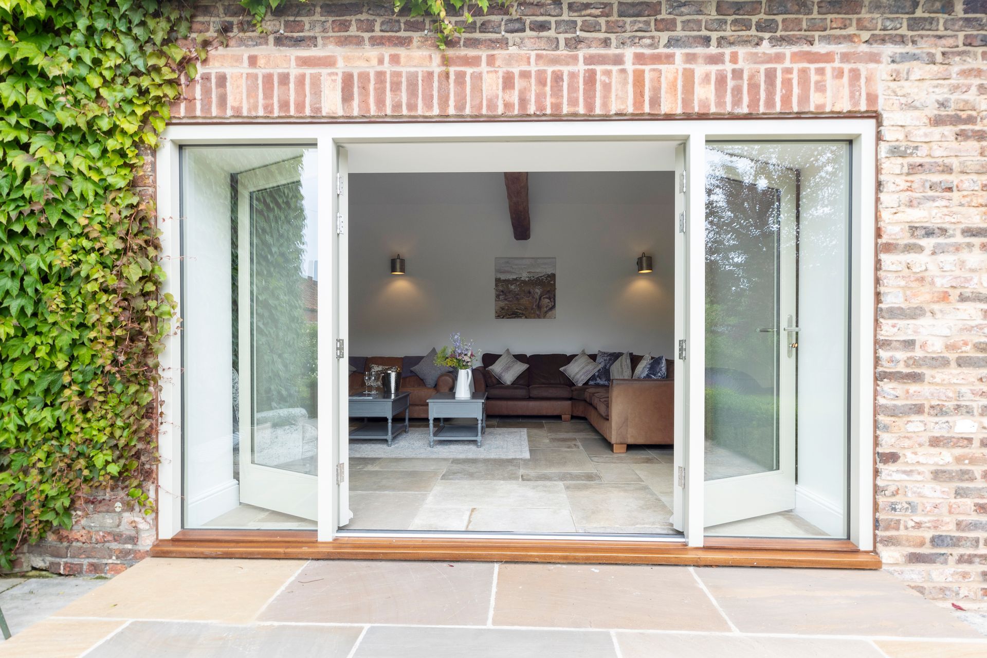 A kitchen with a large island in the middle and a clock on the wall.